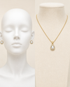 Jewelry set including a necklace and earrings displayed on a mannequin and mannequin head.