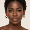 African model wearing Swarneva Navratna cross studs – 28x28mm flower shape, red, green, blue, yellow gems and pearls

