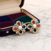 Swarneva Navratna cross studs in dark blue jewel box with multi-color velvet on marble