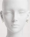 Mannequin head wearing diamond stud earrings on a white background