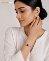 Swarneva silver plated black disc bracelet with clear CZ stone, L48mm x W58mm on Indian female model