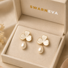 Swarneva Clover Pearl Drops in premium jewelry box, stainless steel gold-tone clover earrings with pearl-white detailing, dimensions 14mm x 14mm.