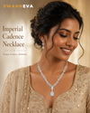 Swarneva Imperial Cadence Necklace on a dark complexion Indian female model in an elegant festive pose, silver-tone necklace with white stones and teardrop drop design, dimensions 220 x 15 mm