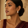 Swarneva gold-tone stainless steel imitation pearl studs, 30mm x 15mm, styled on Indian model for festive elegance