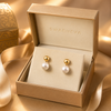 Swarneva gold-tone stainless steel imitation pearl drop stud earrings, 30mm x 15mm, placed in luxury jewelry packaging
