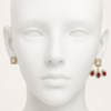 White silicone head showing detachable 2-in-1 earring – left ear stud only, right ear full ruby jacket, Swarneva