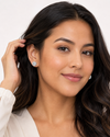 Latina model tucking hair, Swarneva Lumina Circle Earring, 360° pave sparkle visible around center