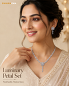 Swarneva Luminary Petal Necklace & Earrings Set on Indian female model in elegant festive pose, silver-tone floral design with sparkling stones, necklace 220 x 30 mm, earrings 35 x 18 mm.