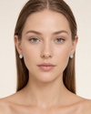 European model wearing Swarneva Micro-Pave Oval Solitaire Earring – white gold, oval white solitaire with micro-pave diamond halo, 10x7mm