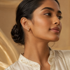 Swarneva gold-tone stainless steel clear stone hoops, 14mm x 14mm, styled on Indian model for daily luxury look