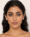 Middle Eastern model wearing Swarneva Round Brilliant Diamond Halo Studs – white gold, white solitaire with blue transparent highlight, 14mm round

