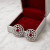 Swarneva Ruby Lattice Studs in silver-grey box with red velvet on white marble