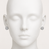 Silver earrings on a mannequin head against a white background