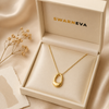 Swarneva The Lumina Midnight Necklace in premium cream Swarneva gift box — hollow gold oval pendant packaging