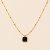 Swarneva The Noir Cube Necklace — matte black enamel square pendant on gold-tone satellite chain, 5.1g, stainless steel, product photography
