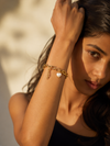 Swarneva Aura Baroque Link Bracelet worn by Indian model raised wrist, chunky gold chain pearl heart charm editorial