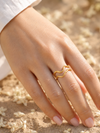 Swarneva Fluid Wave Ring worn by Indian model hand flower petals, double gold wave band ring editorial