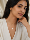 Swarneva Imperial Bloom White Clover Gold Necklace worn by Indian model collarbone, white clover pendant editorial