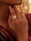 Swarneva Infinity Crystal Baguette Ring worn by Indian model hand jaw, wide gold baguette band infinity loop ring editorial