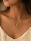 Swarneva Infinity Heart Necklace worn by Indian model collarbone, gold crystal heart infinity pendant editorial