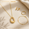 Swarneva The Lumina Midnight Necklace styled flat-lay with complementary gold jewelry — The Swarneva Edit