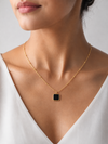 Swarneva Noir Cube Necklace worn by Indian model collarbone, matte black square pendant gold satellite chain editorial