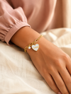 Swarneva Sovereign Split Heart Bracelet worn by Indian model wrist, mixed chain white heart pearl charm editorial