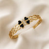 Swarneva Vintage Black Heart Clover Bracelet in gold plated stainless steel with black enamel hearts and clear CZ stones, L48mm × W58mm, clean studio flatlay